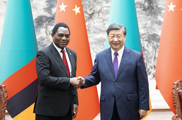 Zambian President Hakainde Hichilema (left) shakes hands with Chinese President Xi Jinping at the Great Hall of the People in Beijing, China